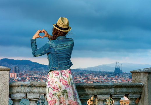 traveller woman in Barcelona, Spain showing heart shaped hands