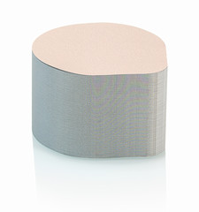 Stacked aluminum heat seal yogurt lids embossed with worm pattern isolated on white background with...