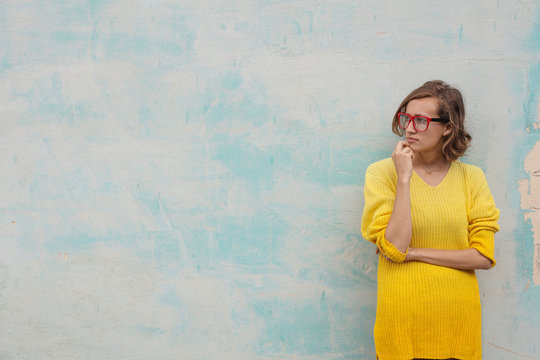 Girl with red glasses and yellow dress