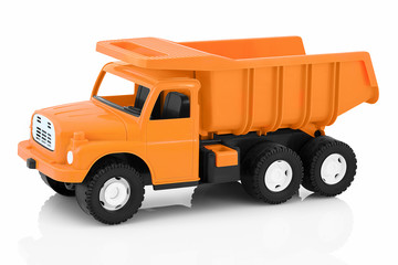 Vintage dump truck isolated on white background with shadow reflection. Plastic child toy on white...