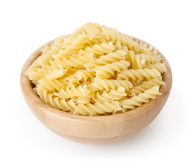 Uncooked fusilli pasta in wooden bowl isolated on white background with clipping path