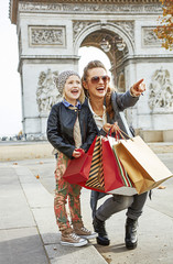 mother and daughter near Arc de Triomphe pointing on something