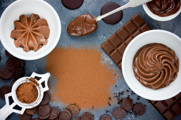 Chocolate background - chocolate ganache, melted chocolate, chocolate cream frosting, cocoa powder empty space for text