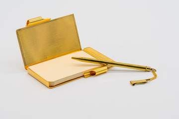 Gold personal vintage notebook case with pen isolated on white