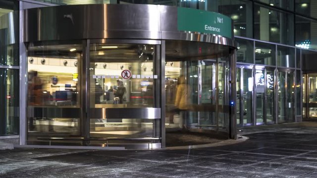 the flow of people through a revolving door at the airport, time lapse
