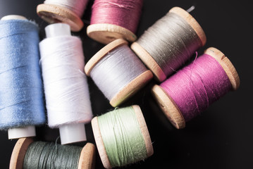 Multi-colored thread close-up on a black background