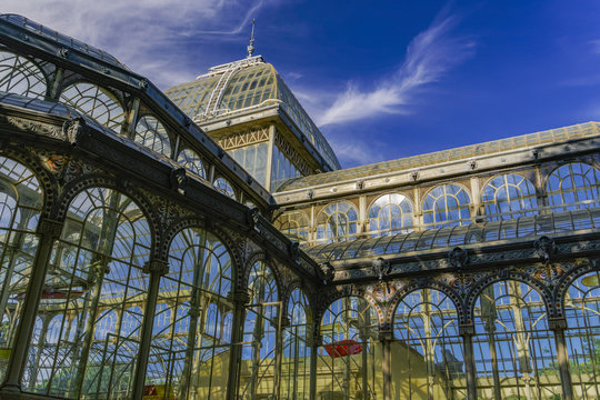 Madrid, Spain Palacio de Cristal iron framework external view detail.
Day view of 1887 glass and metal structure of crystal palace at Park Retiro.