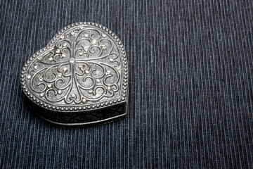 Old vintage silver heart-shaped casket on gray background. Isolated