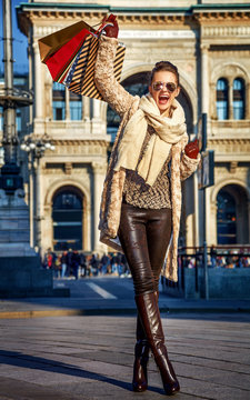 happy woman at Piazza del Duomo in Milan, Italy rejoicing