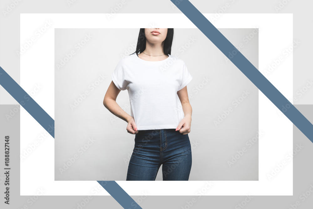 Wall mural young woman in blank t-shirt on white with creative frame