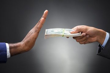 Close-up Of A Man's Hand Refusing Bribe