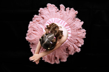 A young girl dressed as a ballerina taken from above