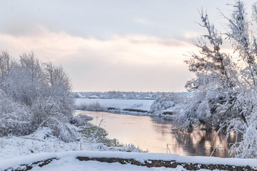 View from Lutsk park into the Styr river during winter snowfall. Lutsk, Ukraine.