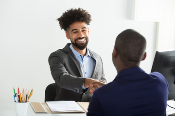 Businessman Shaking Hand With Male Candidate