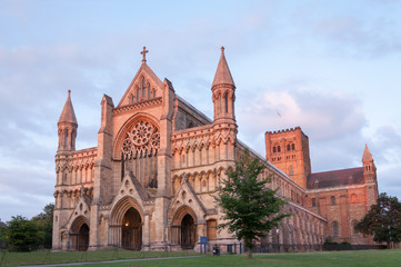 St Albans Cathedral at sunset with the end of the sunshine shining on the front doors
