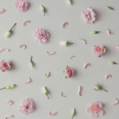 Creative pattern made of violet and pink flowers. Flat lay. Minimal season background.