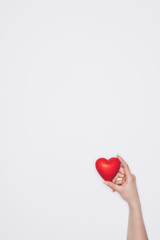 cropped shot of woman holding small red heart isolated on white