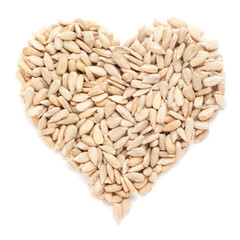 Organic Sunflower seed (Helianthus annuus)  in Heart Shape. Isolated on White Background.  Micro Closeup, Top view.