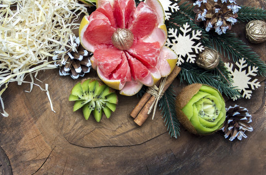 composition of fresh carved fruits decorated with fir branches