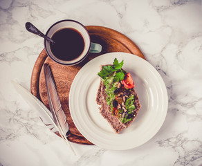 Toast of gluten fries with guacamole. A cup of coffee. Breakfast. Wooden board.Marble background. Top view.Tone.