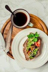 Toast of gluten fries with guacamole with tomatoes, seeds and herbs. A cup of coffee. Breakfast. Wooden board.Top view.