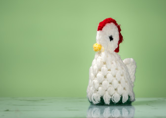 Closeup of an egg cozy, knitted chicken