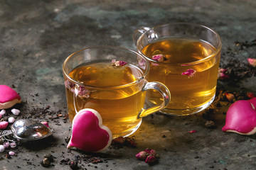 Love Valentines day greeting card with two glasses of hot tea, rose buds, heart shape homemade...