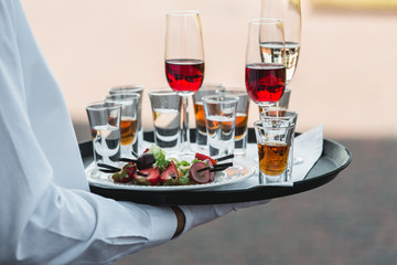 Catering services. Celebration. glasses with alcohol on a tray.