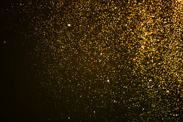 Fototapeta na wymiar christmas gold sparkle glitter explosion dust particles background with bokeh, gold holiday happy new year and valentine day concept