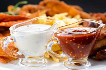 Food background with delicious fried potato and sauces, close-up