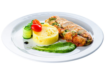 Grilled chicken fillet with pesto and sauce in a white plate isolated on white background