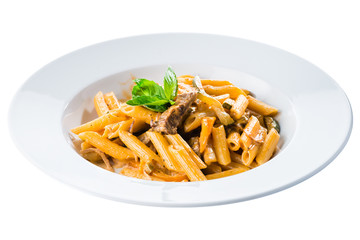 Traditional Italian cuisine. Penne pasta in tomato sauce with chicken decorated with basil in a white plate isolated on white background