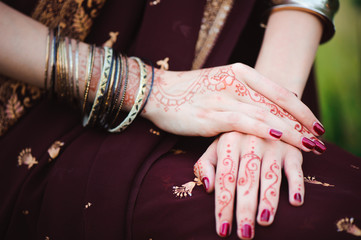Mehndi covers hands of Indian woman
