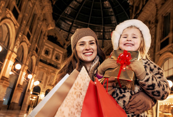 mother and child tourists with Christmas shopping bags in Milan