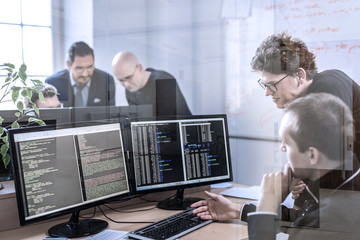 Startup business and entrepreneurship problem solving. Young AI programmers and IT software...