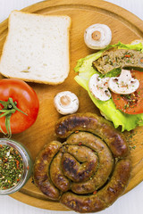 homemade sausage and sandwich with sausage, mushrooms and tomato