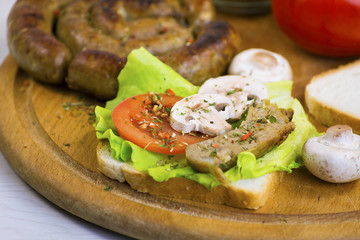 homemade sausage and sandwich with sausage, mushrooms and tomato
