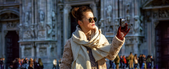 traveller woman in Milan with digital camera taking photo