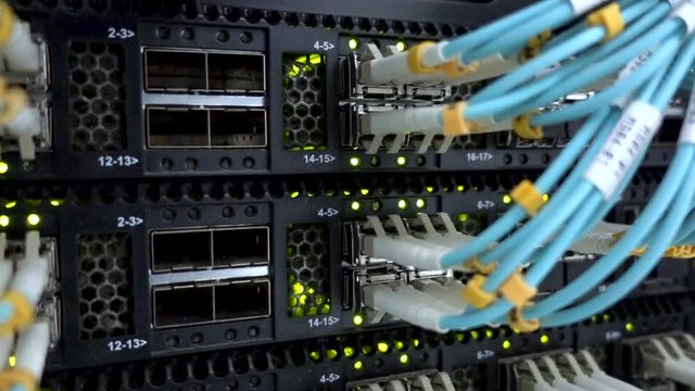 Fiber Optical connector interface. Rack Mounted Servers In A Server Room, Server rack audio cable. Severs computer in a rack at the large data center