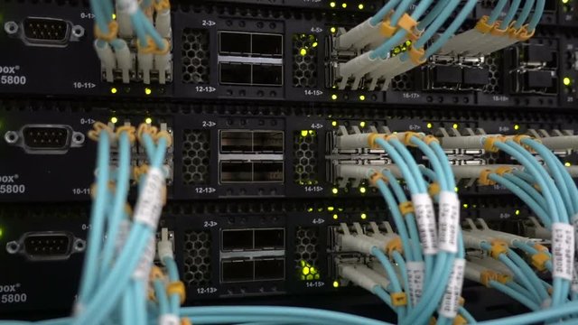 Fiber Optical connector interface. Rack Mounted Servers In A Server Room, Server rack audio cable. Severs computer in a rack at the large data center