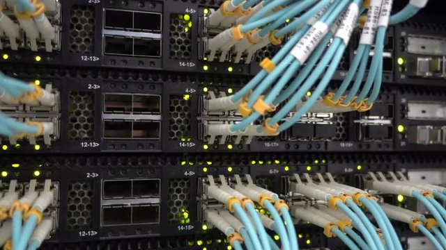 Fiber Optical connector interface. Rack Mounted Servers In A Server Room, Server rack audio cable. Severs computer in a rack at the large data center