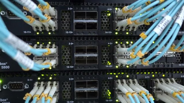 Fiber Optical connector interface. Rack Mounted Servers In A Server Room, Server rack audio cable. Severs computer in a rack at the large data center