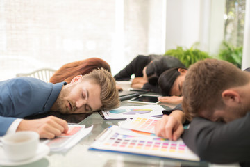 Tired business worker at conference in the office