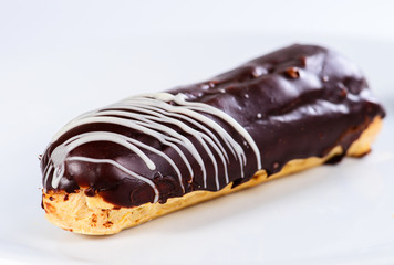 Appetizing sweet dessert. Dark glaze cupcake on light background, selective focus