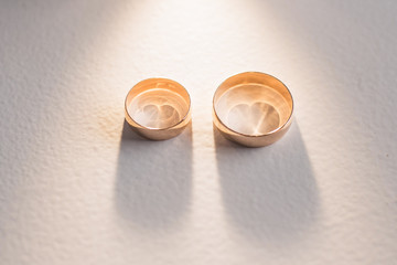Closeup view of two golden shiny rings. Horizontal clor photography.