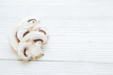 Preparing Healthy Food, Vegeterian, Vegan Concept. White wooden background with sliced champignone, close up, copy space, top view