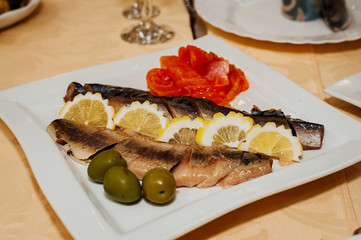 Herring with black olives and red fish