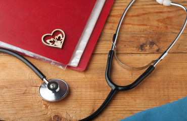 Desk doctor, wooden background, stethoscope,