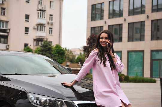 Woman Standing Near Car And Calling By Phone