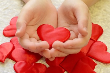 Red heart on the childs hands 